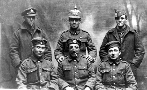 1WW A GROUP OF BRITISH SOLDIERS ON LEAVE IN DEVON SHOWING FF CAPTURED GERMAN HELMETS AND OTHER EQUIPMENT