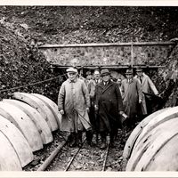 The Chairman and Vice Chairman of the North Devon Water Board emerge from the Prewley tunnel. Note the concrete panels used to construct the tunnel.