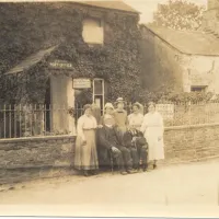 Family group outside the old Post Office in Lydford