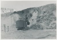 Digger working hard to collect clay during a severe winter