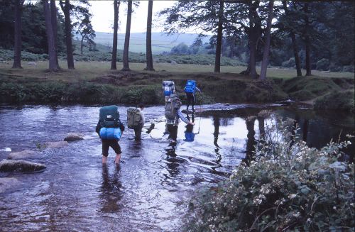 Walkers fording a river