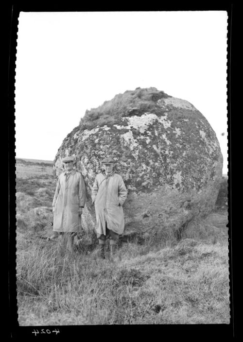 Mr. C. Hallett Watt and Mr. R. Collins standing by large boulder near the Hart Tor brook